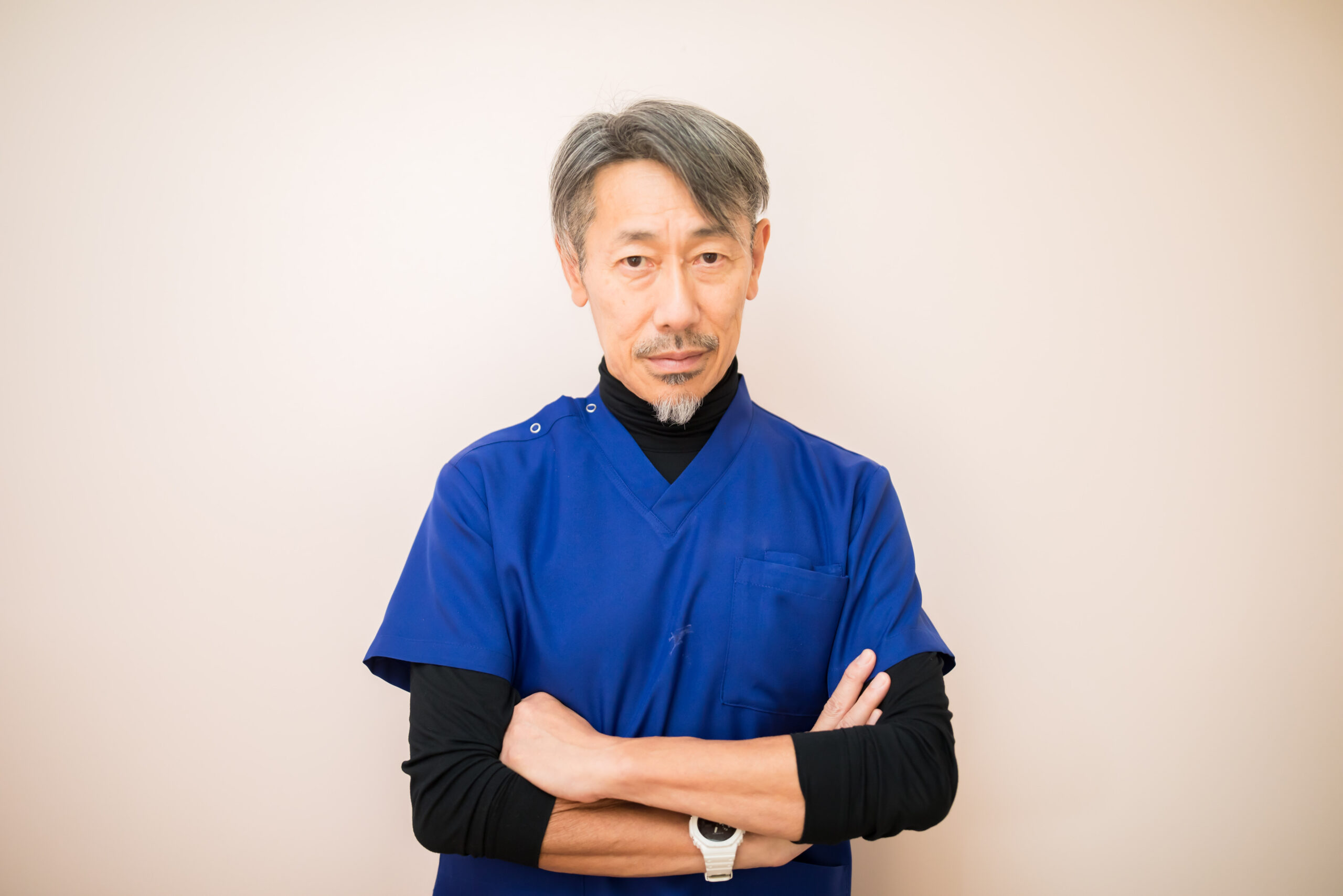 腕を組んで立つ院長 藤原成樹